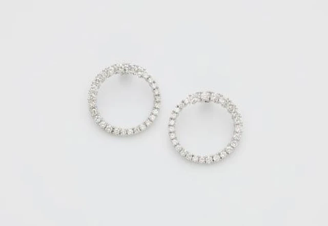 A pair of 18k white gold and diamond loop stud earrings.