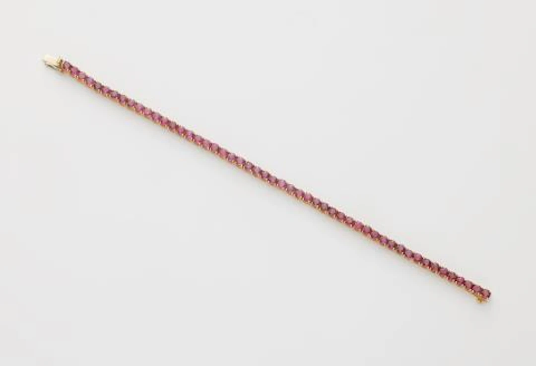 An 18k white gold and ruby rivière bracelet.