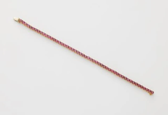 An 18k white gold and ruby rivière bracelet.