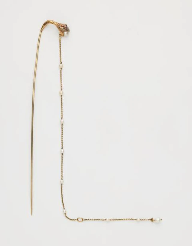 An Art Nouveau 15k yellow gold ruby and baroque pearl hat pin.