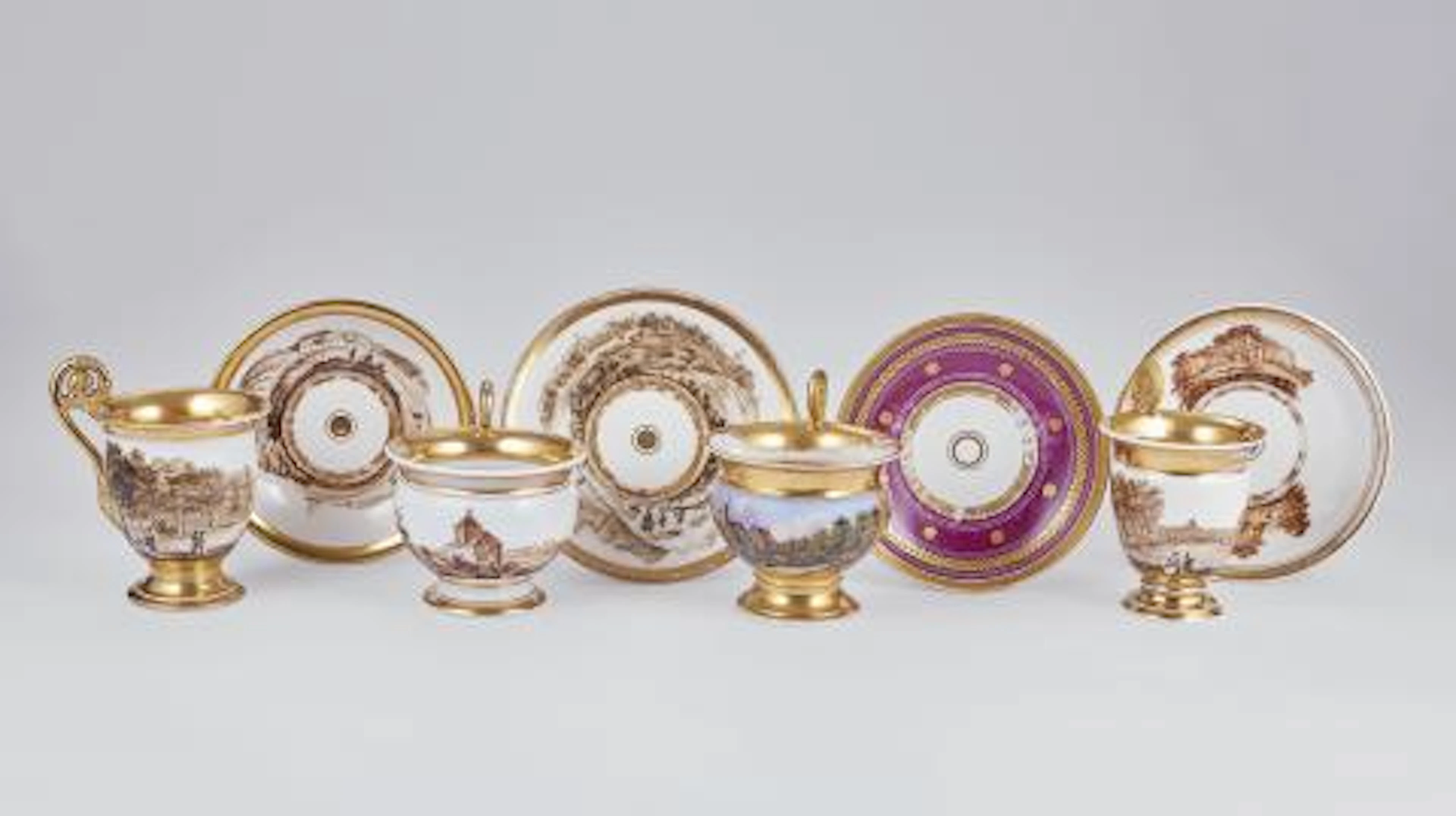 Four large porcelain cups and saucers with Dutch landscapes