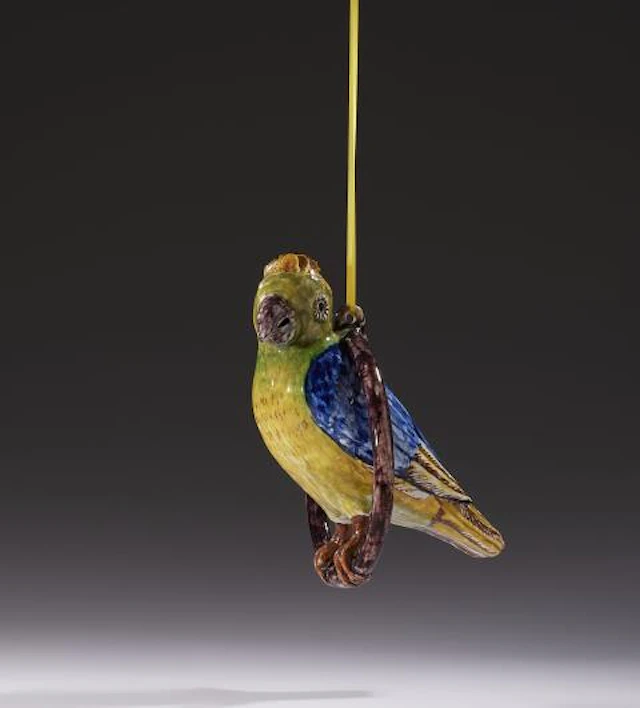 A Dutch Delft figure of a parrot in a ring