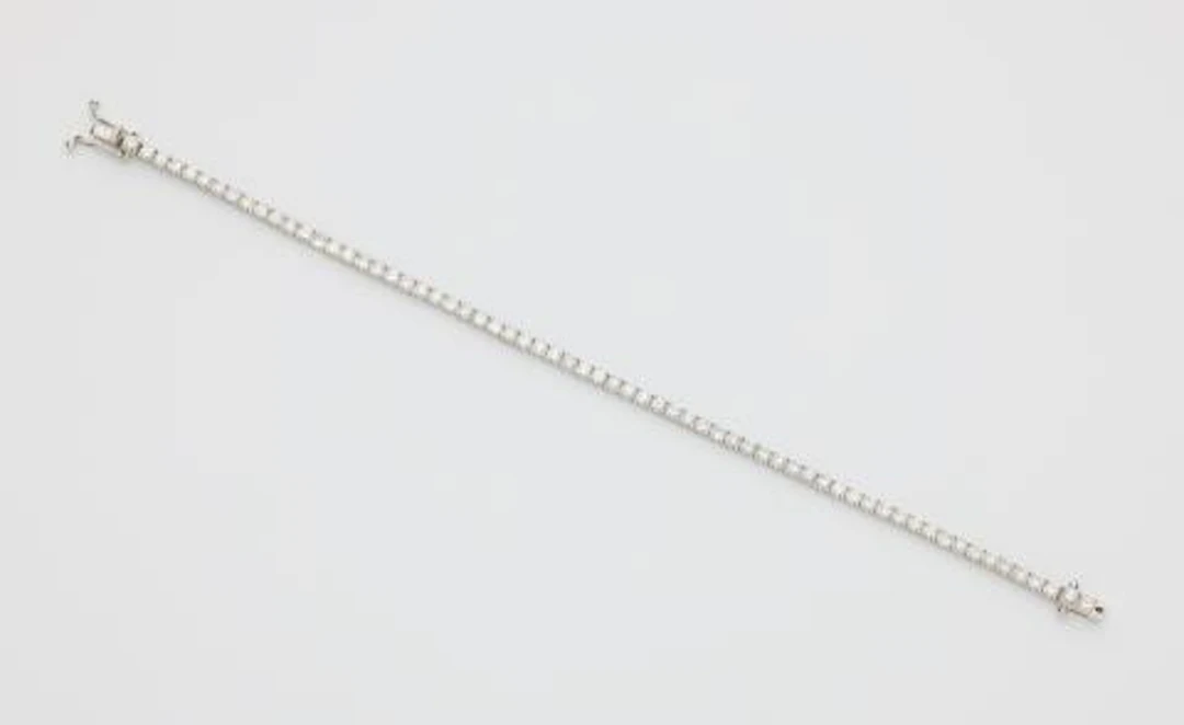 An 18k white gold and brilliant-cut diamond rivière bracelet.