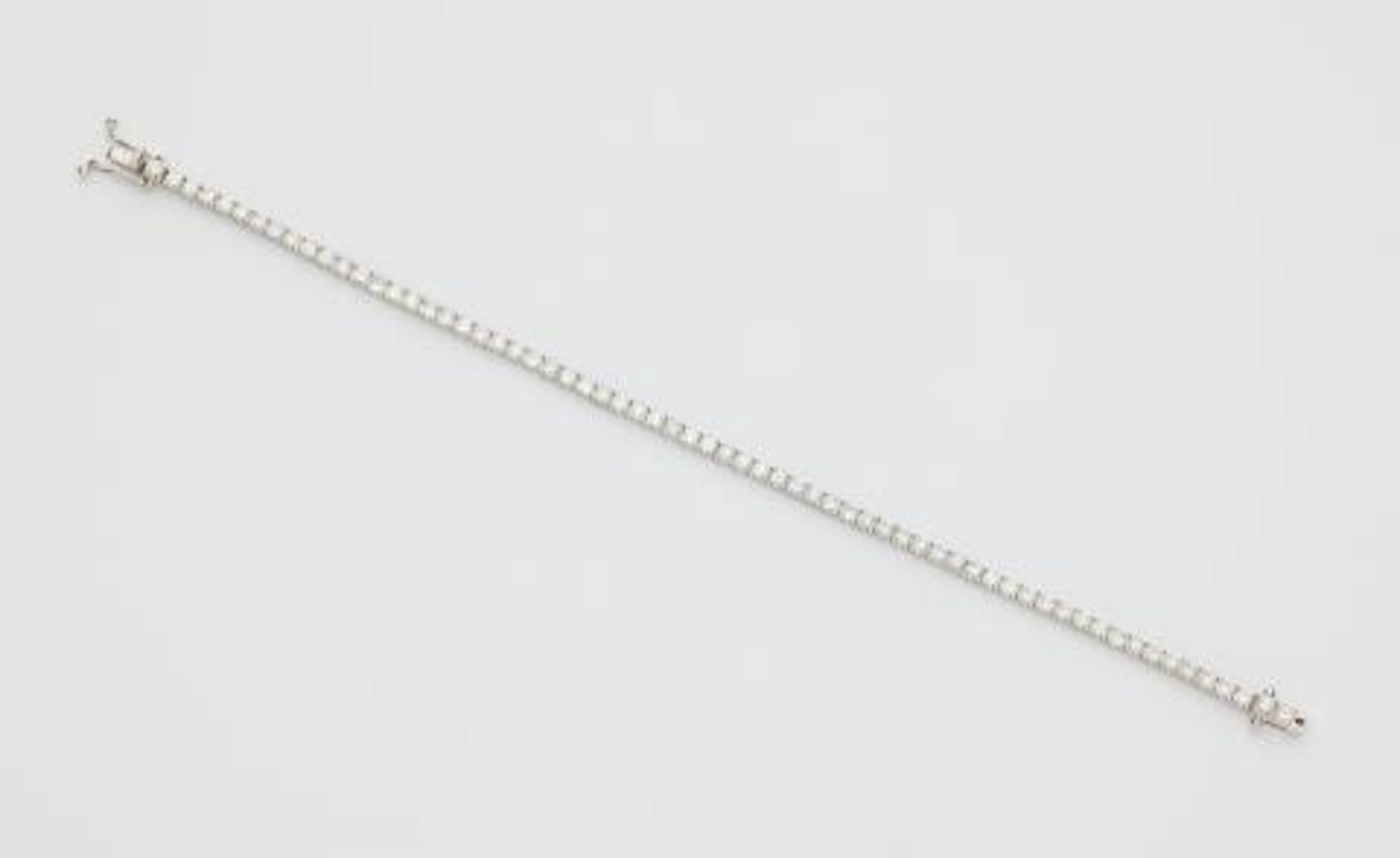 An 18k white gold and brilliant-cut diamond rivière bracelet.