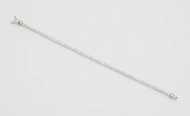 An 18k white gold and brilliant-cut diamond rivière bracelet.