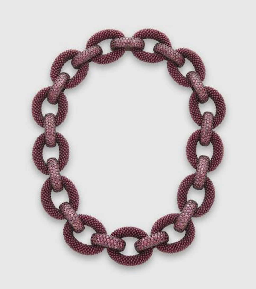 An 18k white gold oxydised silver interwoven garnet and natural burgundy