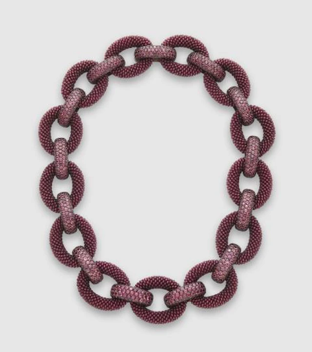 An 18k white gold oxydised silver interwoven garnet and natural burgundy