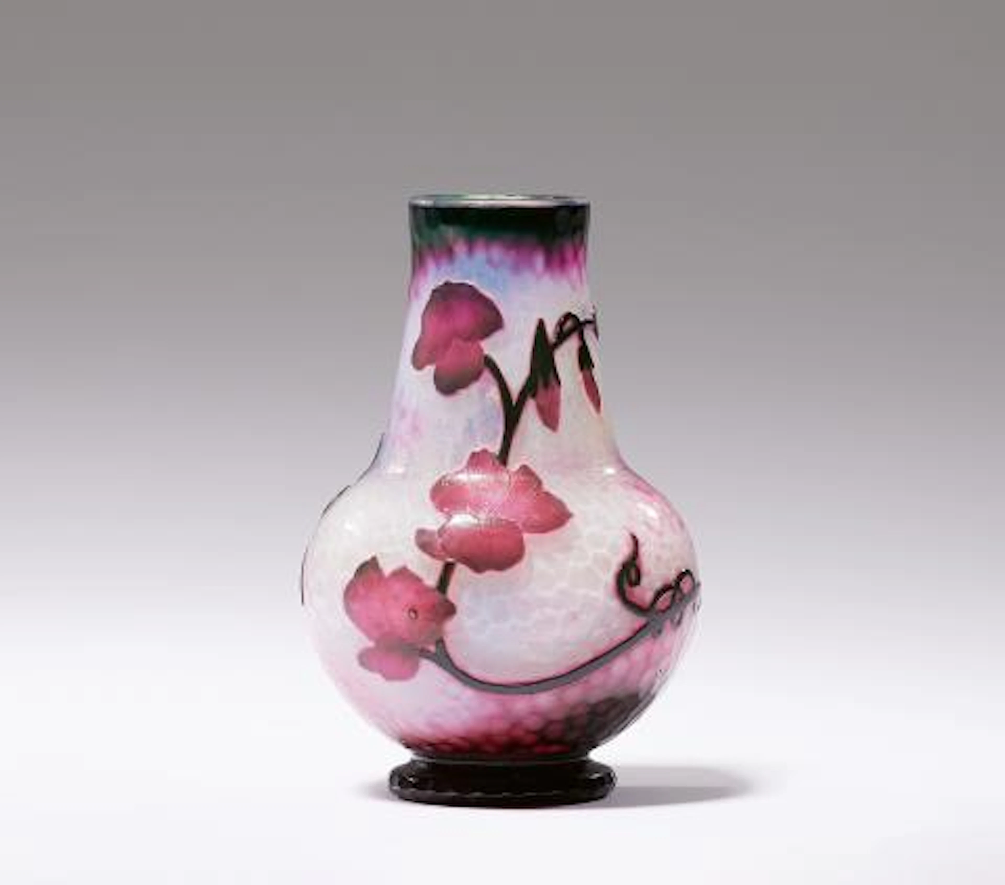 A small Daum Frères glass vase with sweet pea designs