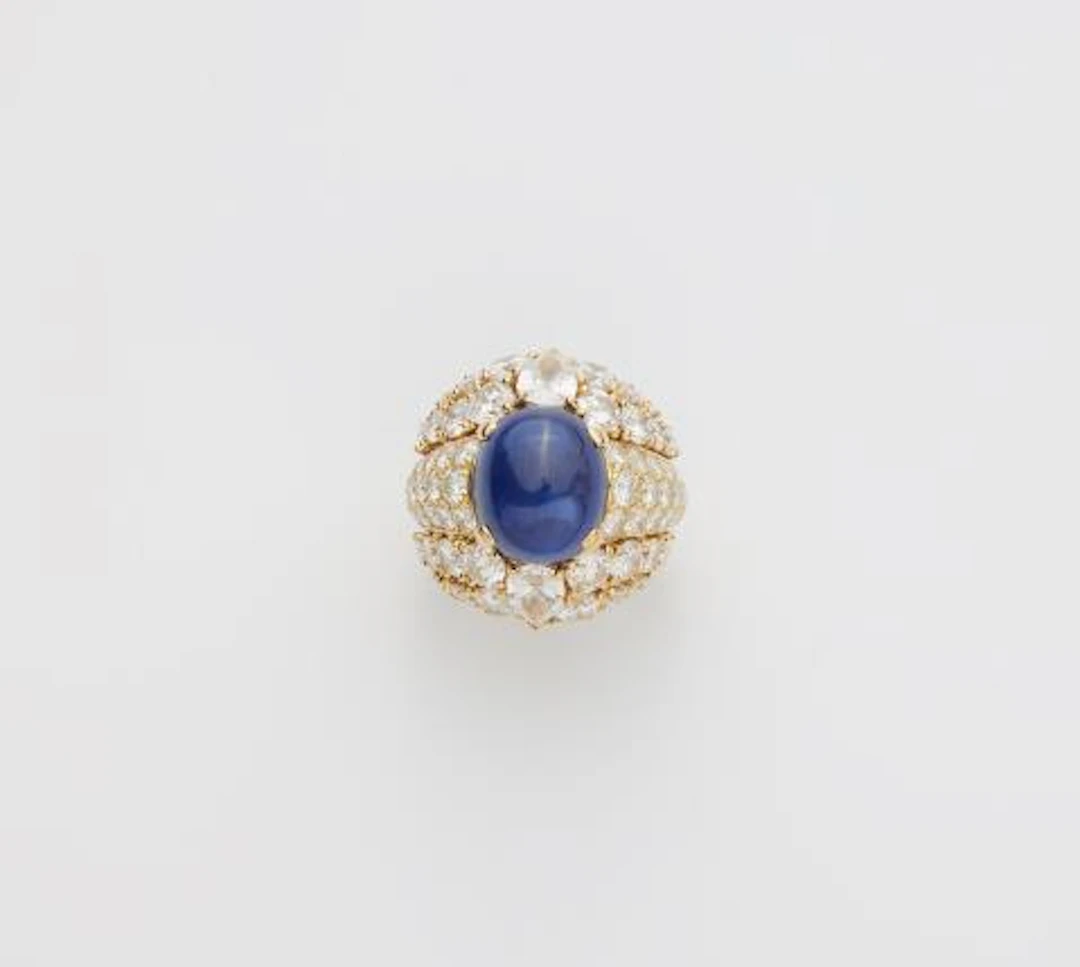 A French 18k yellow gold diamond and royal blue sapphire cabochon