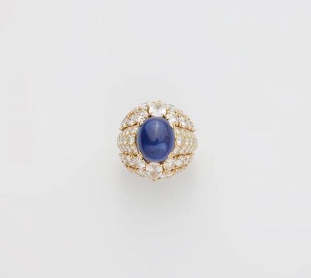 A French 18k yellow gold diamond and royal blue sapphire cabochon
