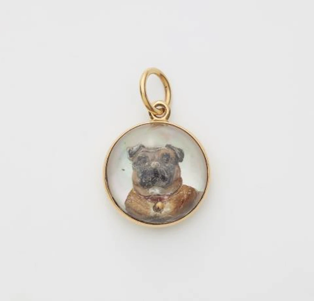 An 18k gold mother of pearl and Essex Crystal intaglio pendant depicting