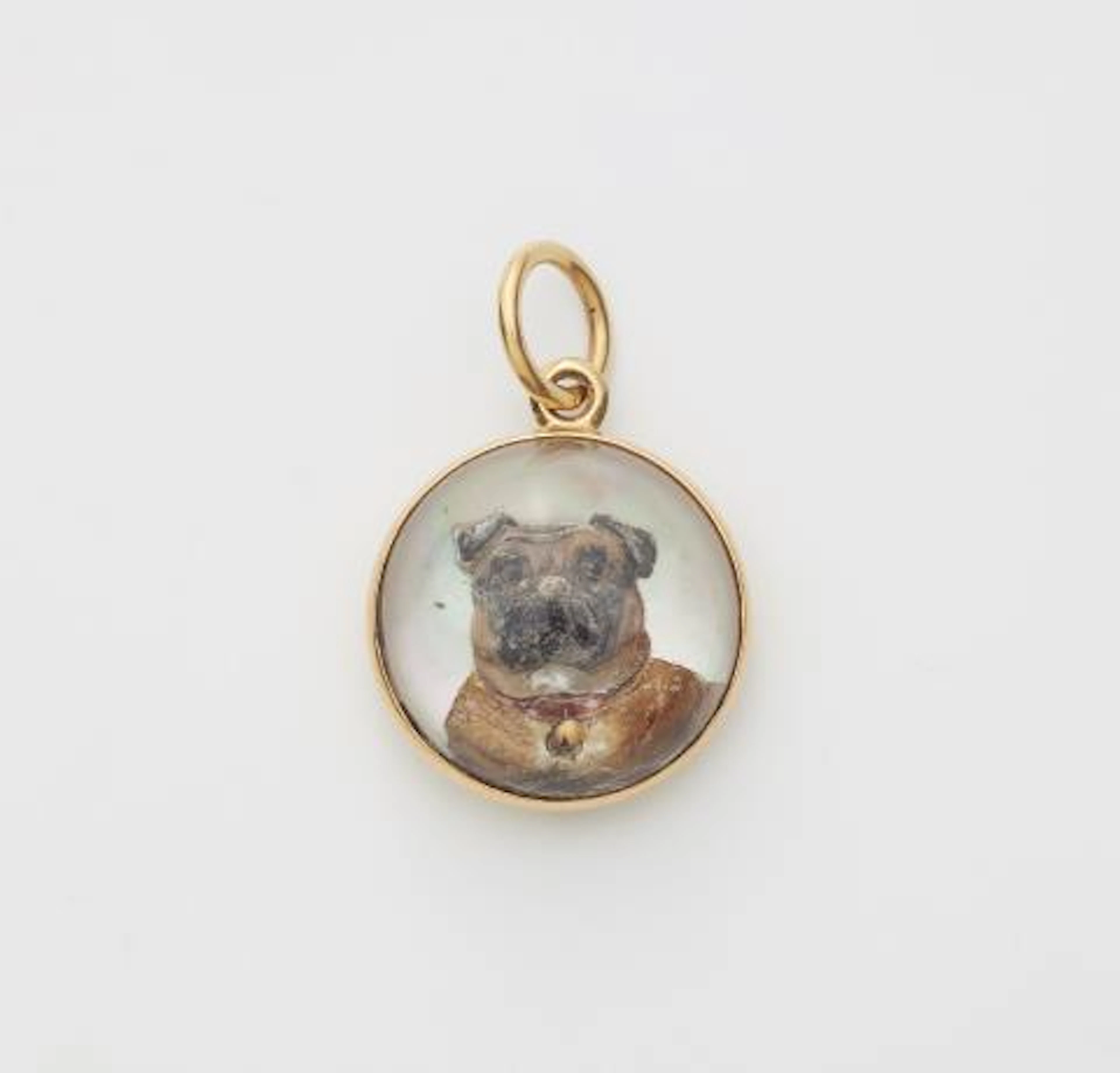 An 18k gold mother of pearl and Essex Crystal intaglio pendant depicting
