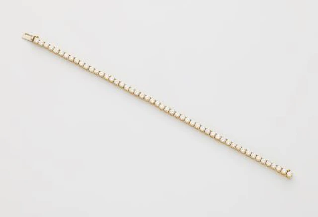An 18k gold and brilliant-cut diamond line bracelet.