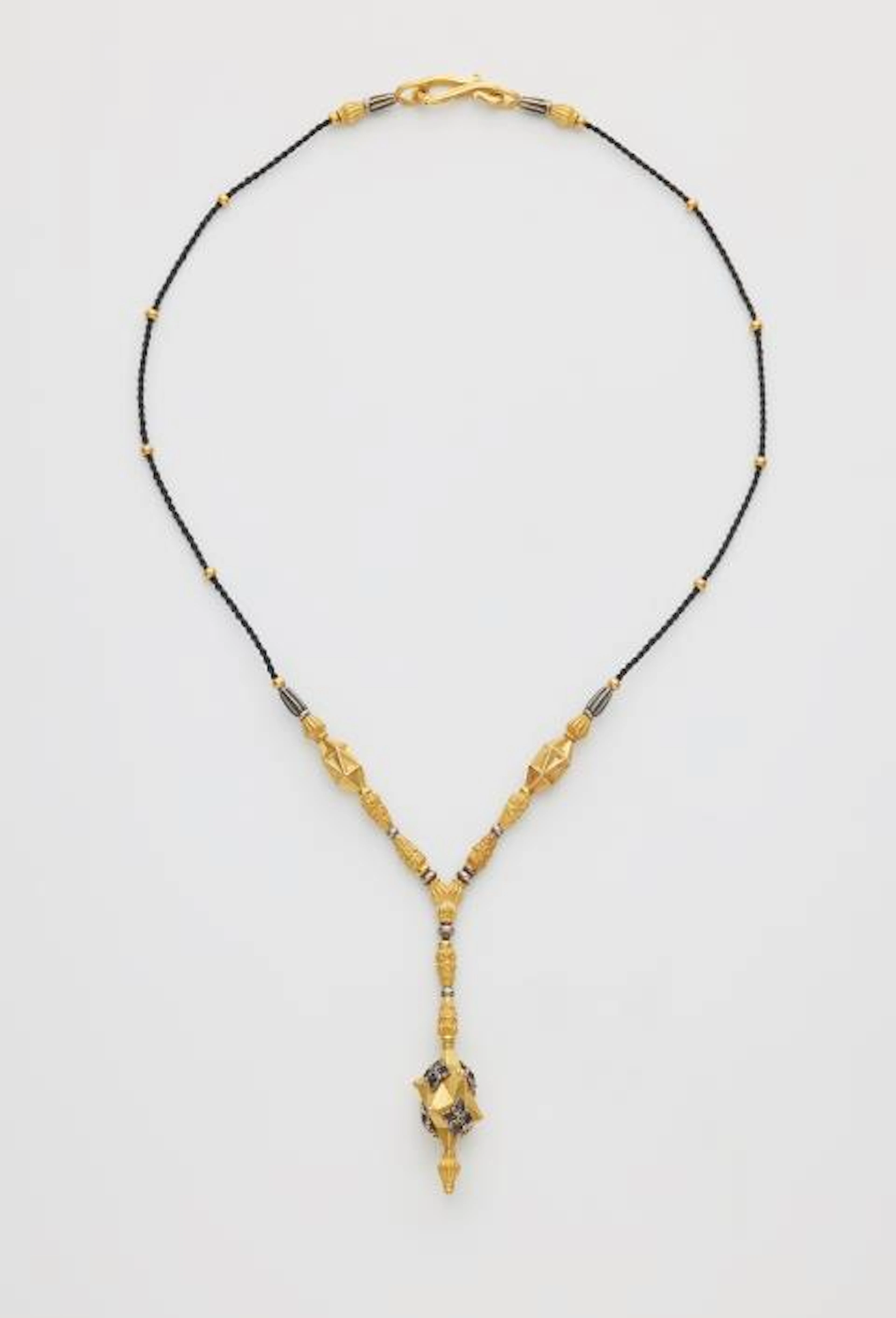 A forged one of a kind 21,6k yellow gold and oxydised 18k white gold