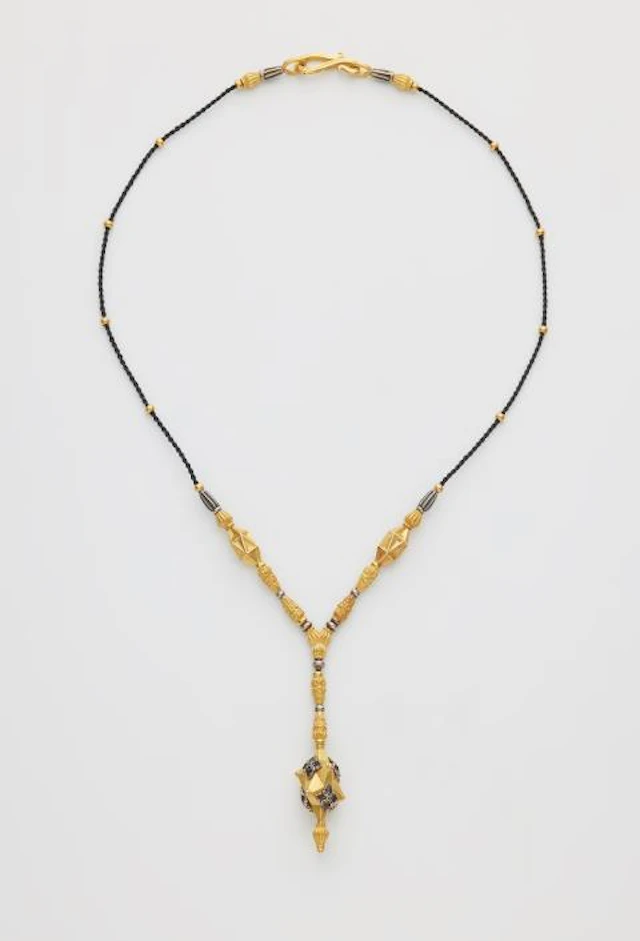 A forged one of a kind 21,6k yellow gold and oxydised 18k white gold