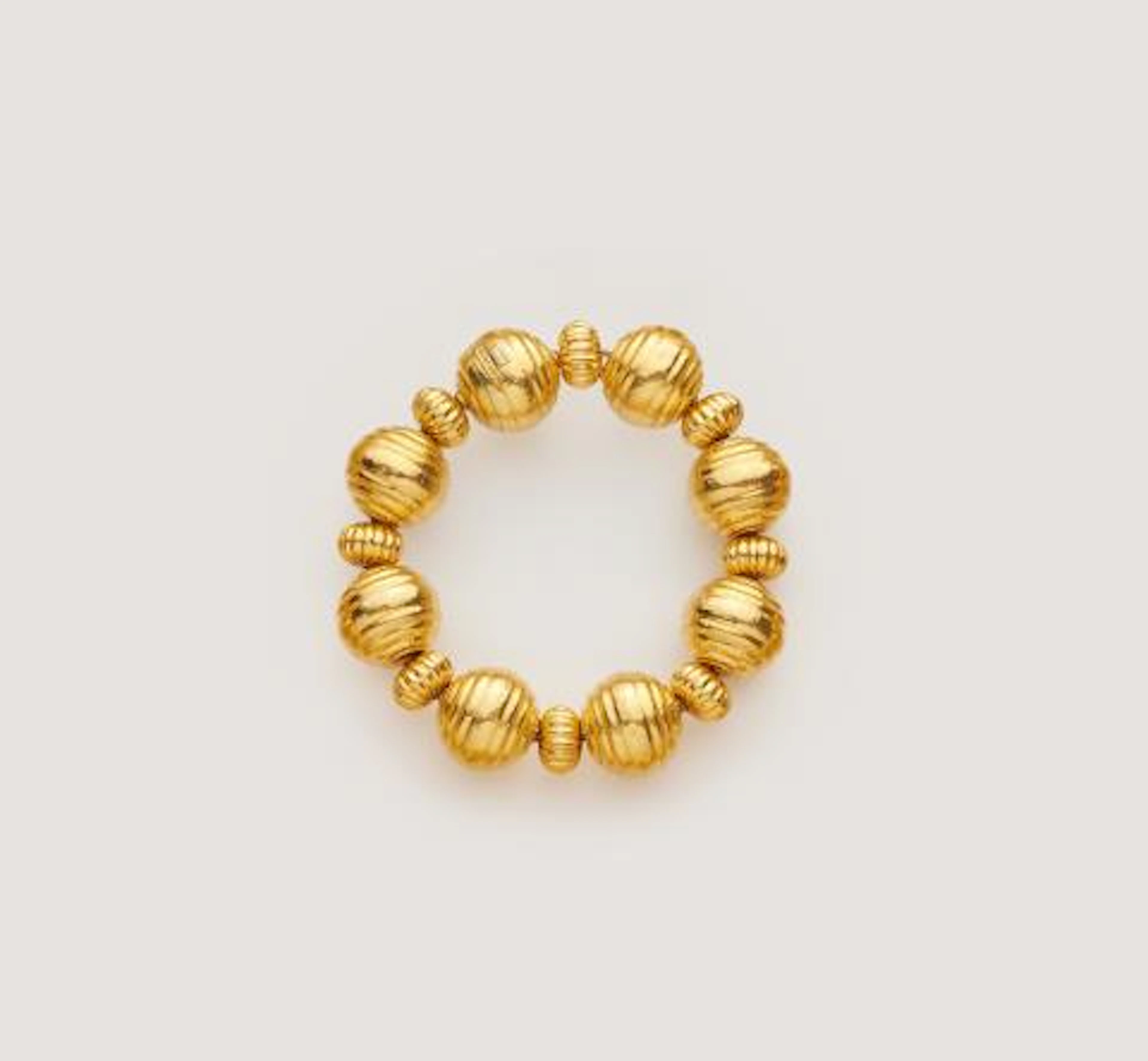 A Greek 18k yellow gold ribbed bead bracelet.