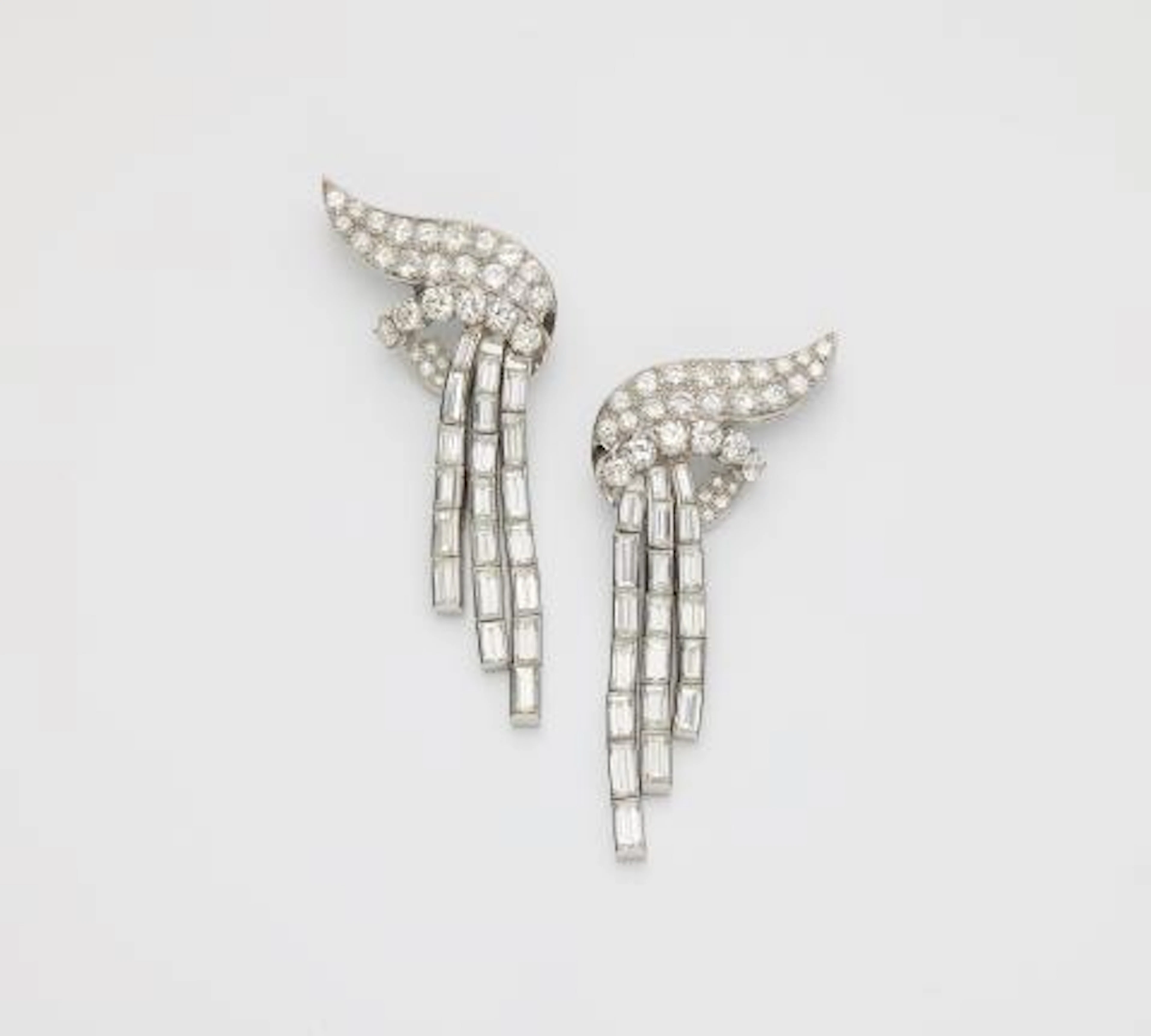 A pair of platinum and diamond cascade earrings later modified into