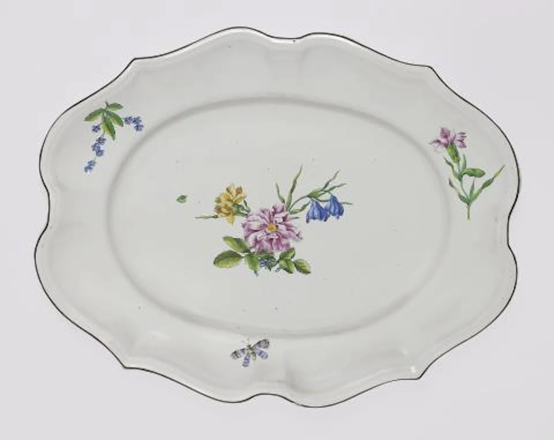 A Strasbourg faience plate with finely painted flowers