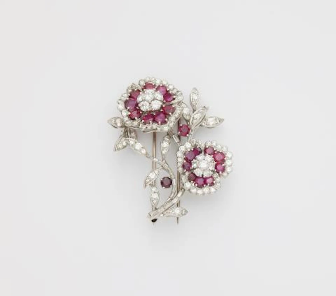 An American platinum 18k gold diamond and ruby rose sprig clip brooch.