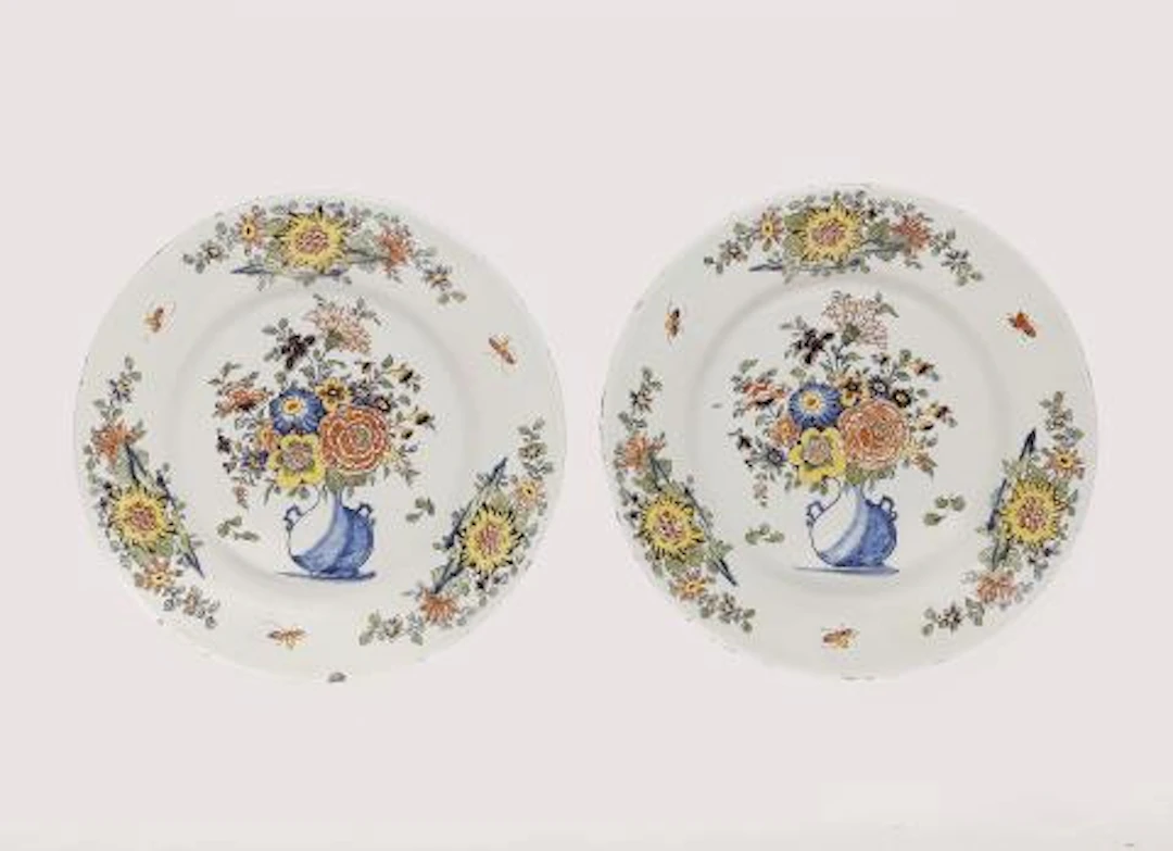 Two Dutch Delft faience plates with vase motifs