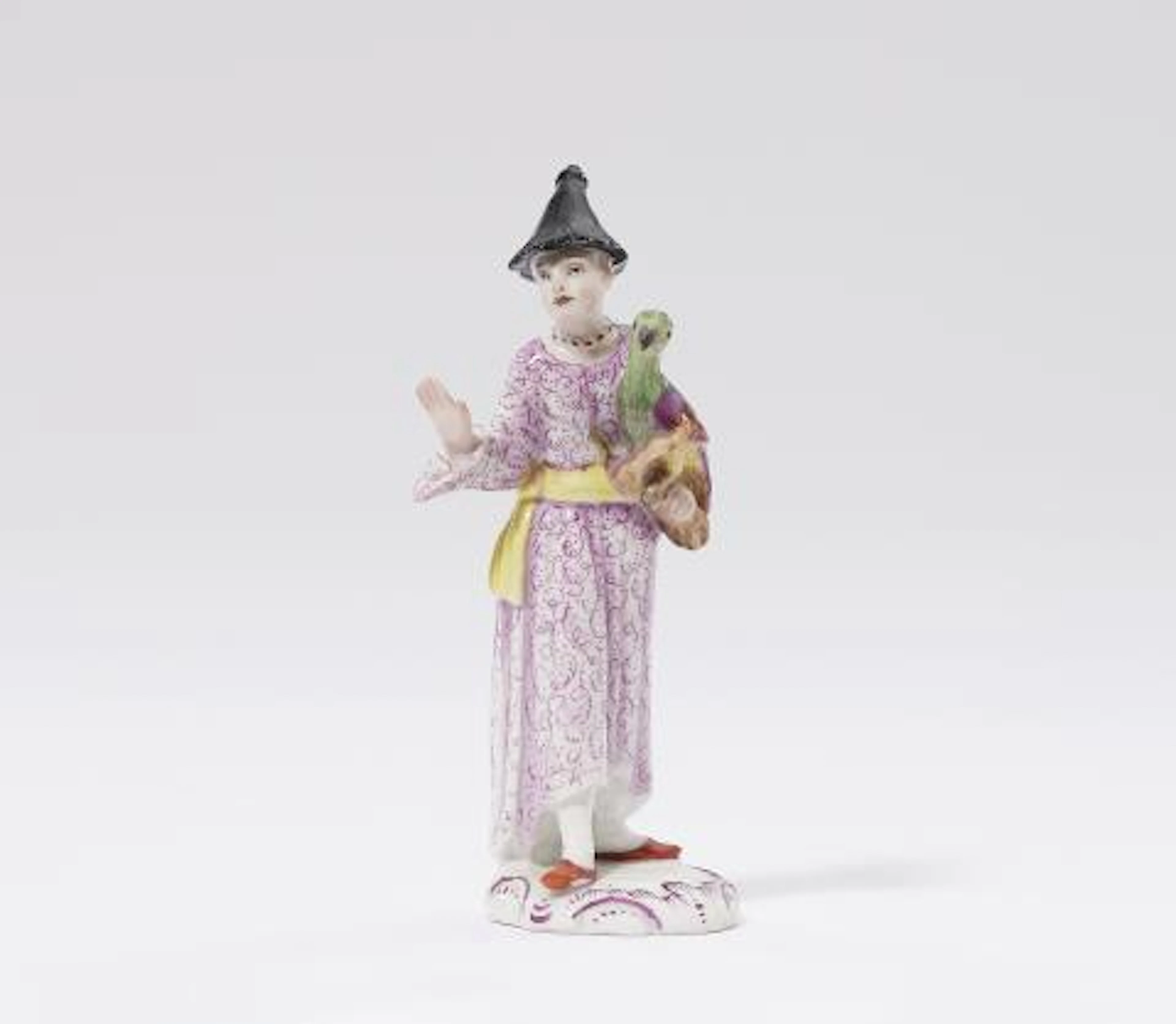 A rare Fürstenberg porcelain figure of a Chinese lady with a parrot