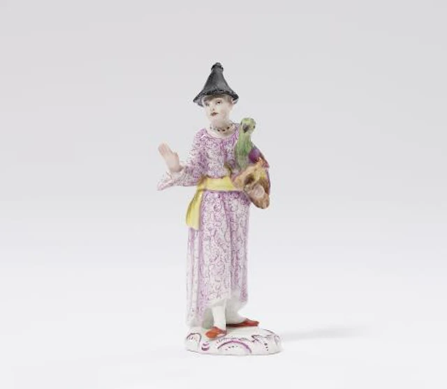 A rare Fürstenberg porcelain figure of a Chinese lady with a parrot