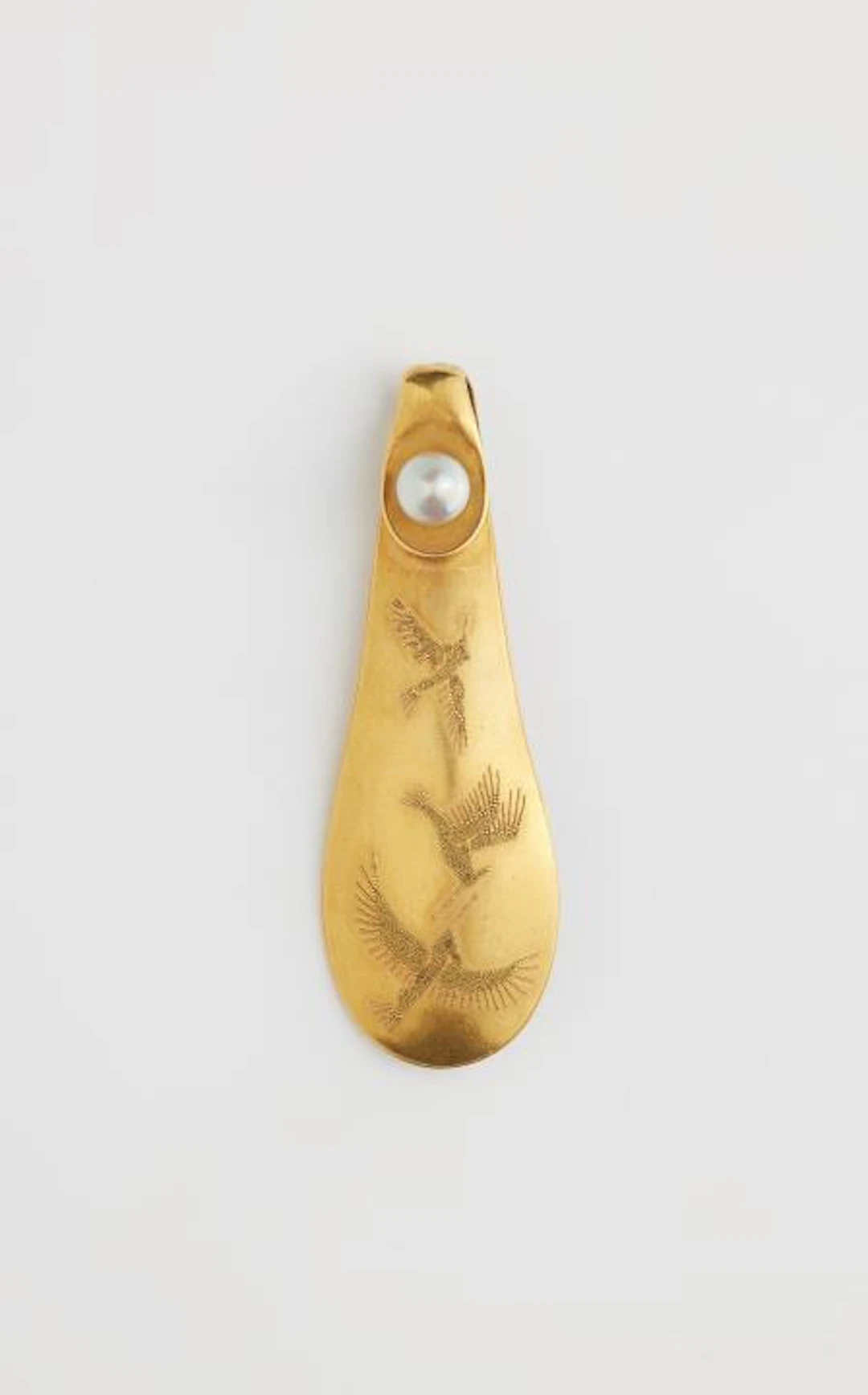 A German 18k gold granulation brooch depicting hummingbirds in flight.