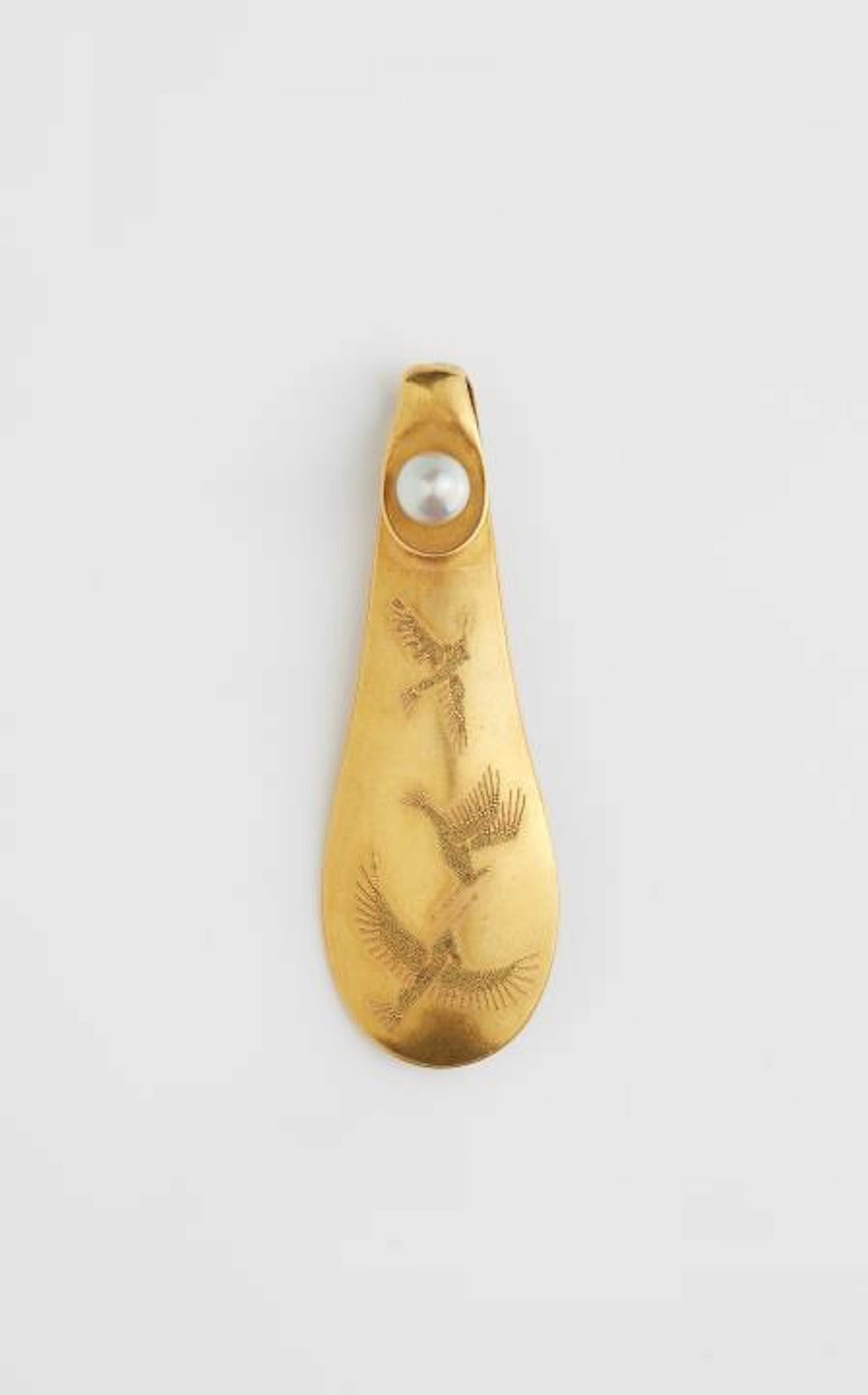 A German 18k gold granulation brooch depicting hummingbirds in flight.
