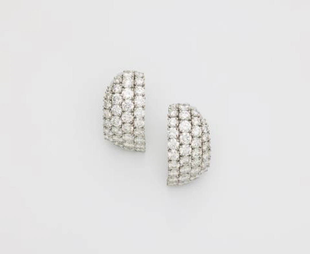 A pair of French platinum and diamond creole clip earrings.