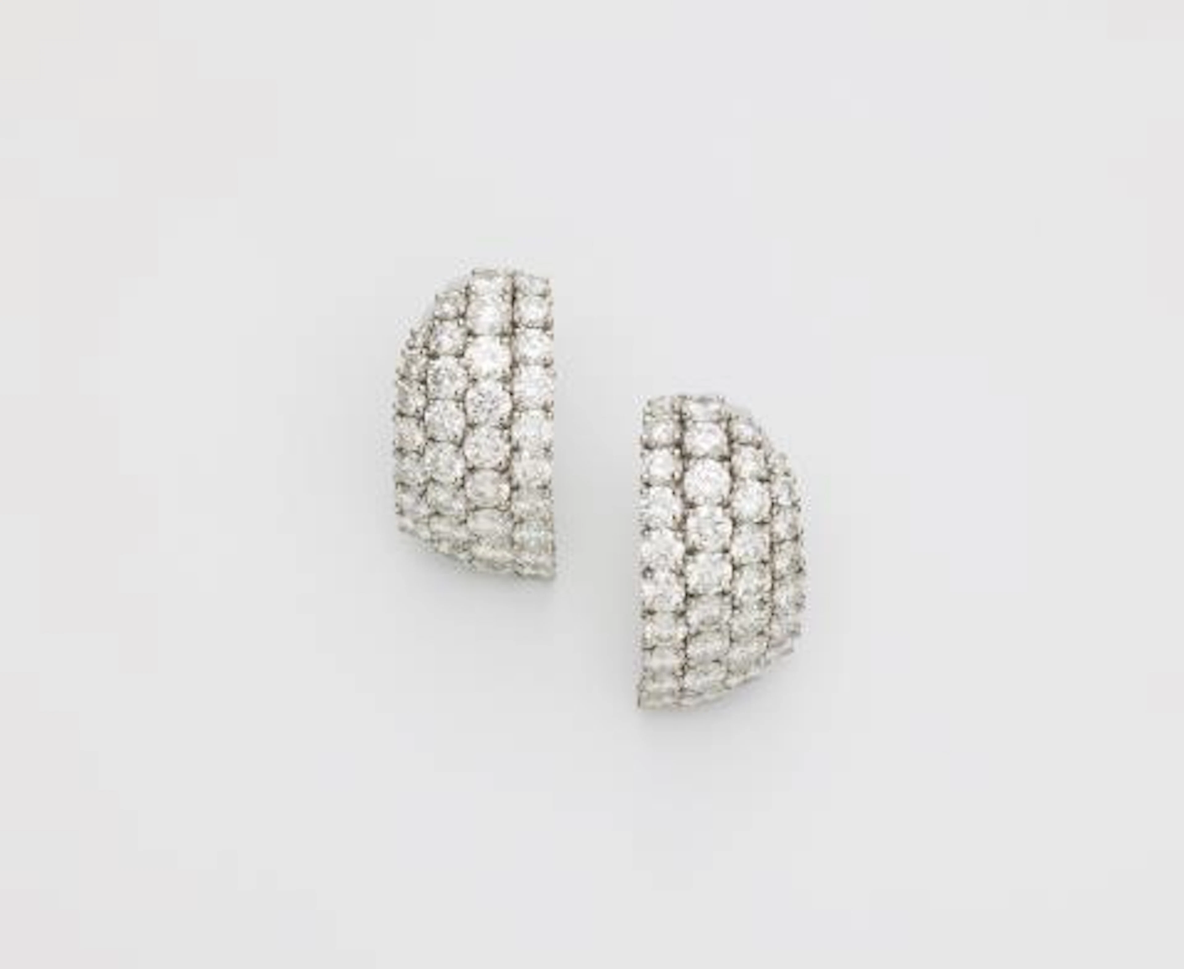 A pair of French platinum and diamond creole clip earrings.