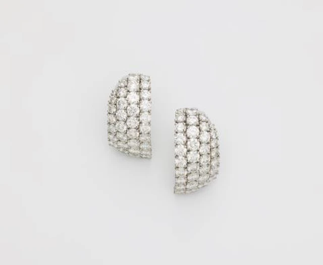 A pair of French platinum and diamond creole clip earrings.