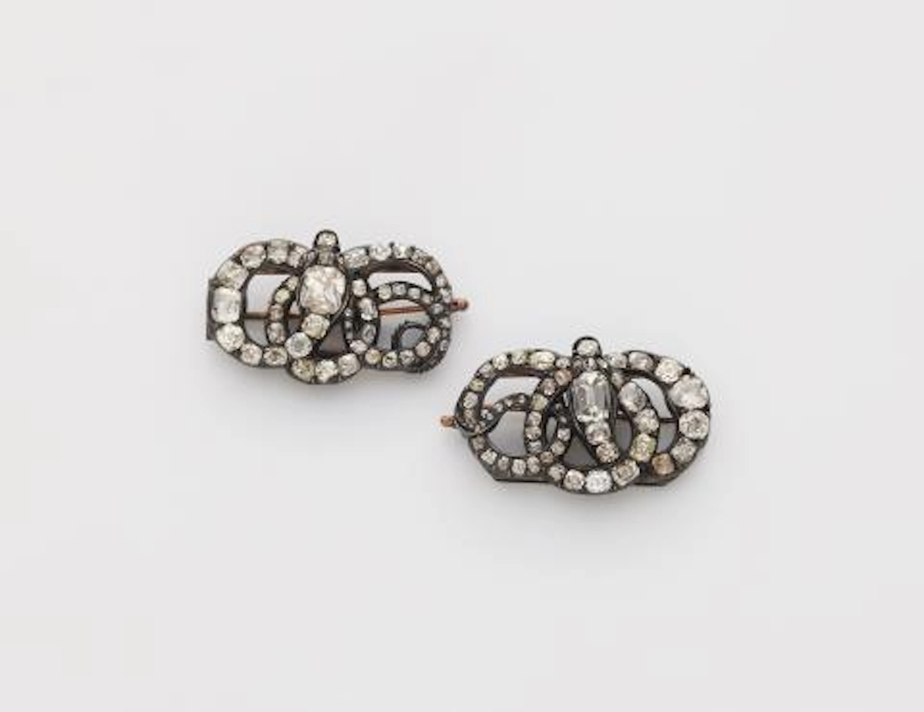 A pair of silver and diamond George III snake miniature brooches with