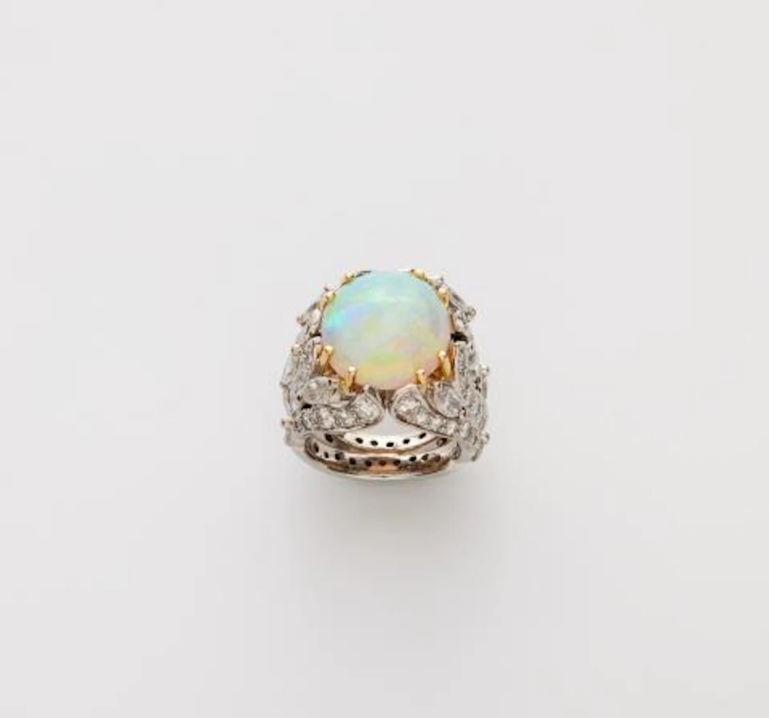An 18k gold diamond and opal cabochon cocktail ring.