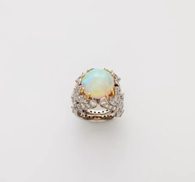 An 18k gold diamond and opal cabochon cocktail ring.