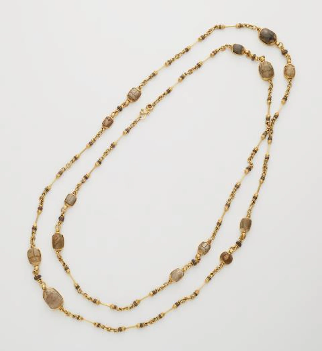 A German hand-forged 21.6k yellow gold and ancient Egyptian greenish