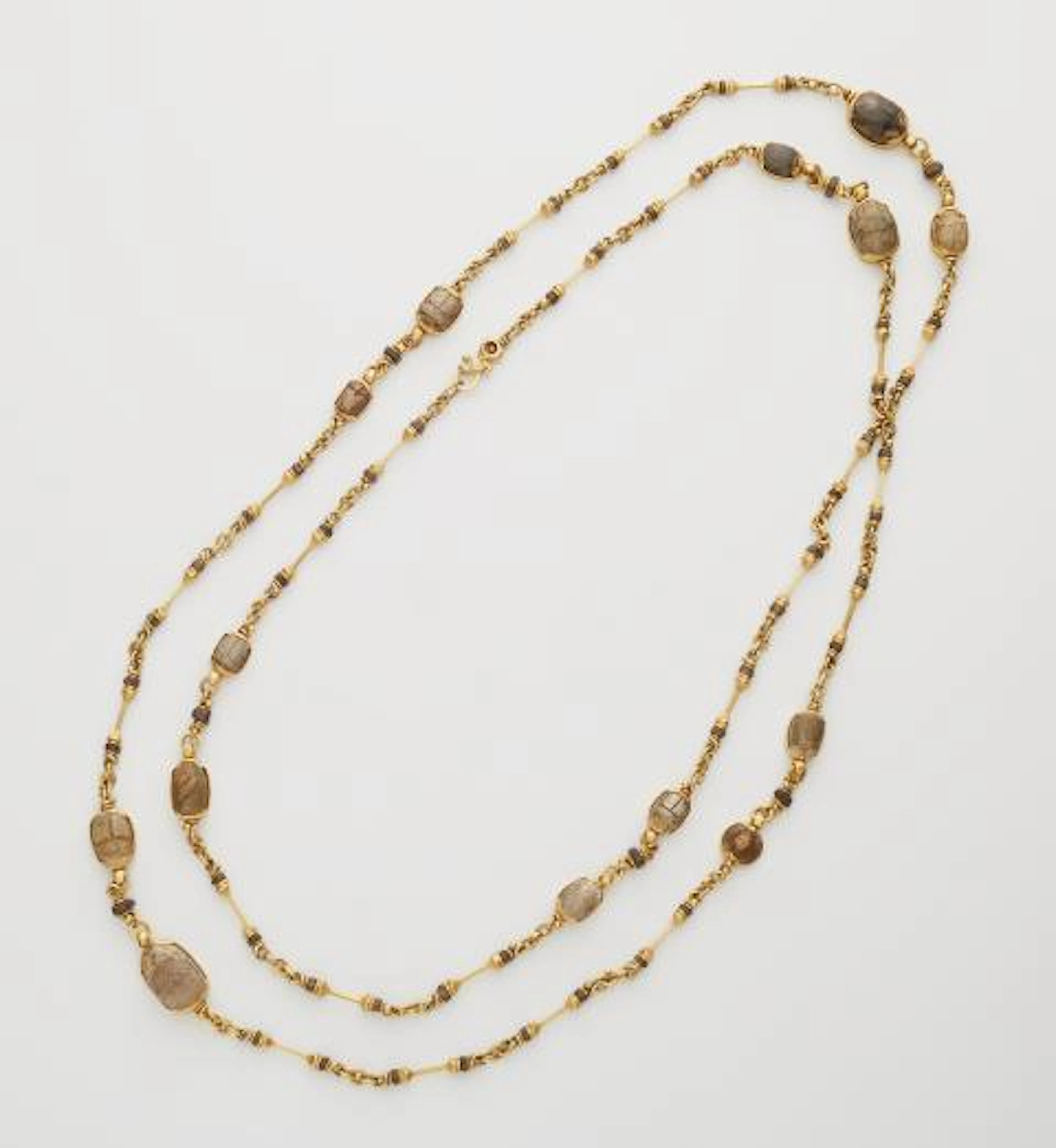 A German hand-forged 21.6k yellow gold and ancient Egyptian greenish