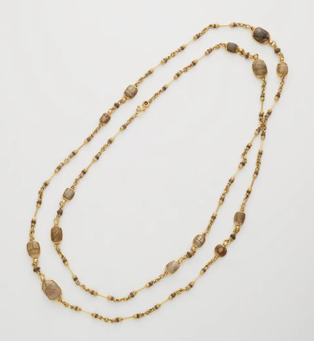 A German hand-forged 21.6k yellow gold and ancient Egyptian greenish