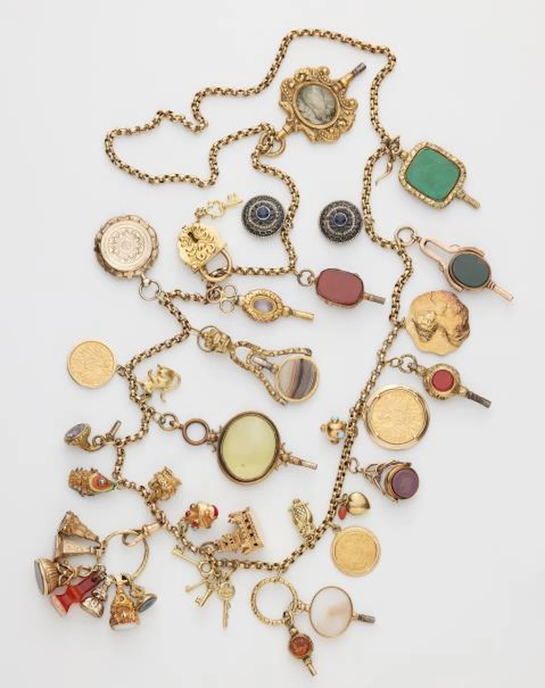 A long 9k gold chain with 30 partially multi-part gold and metal charms