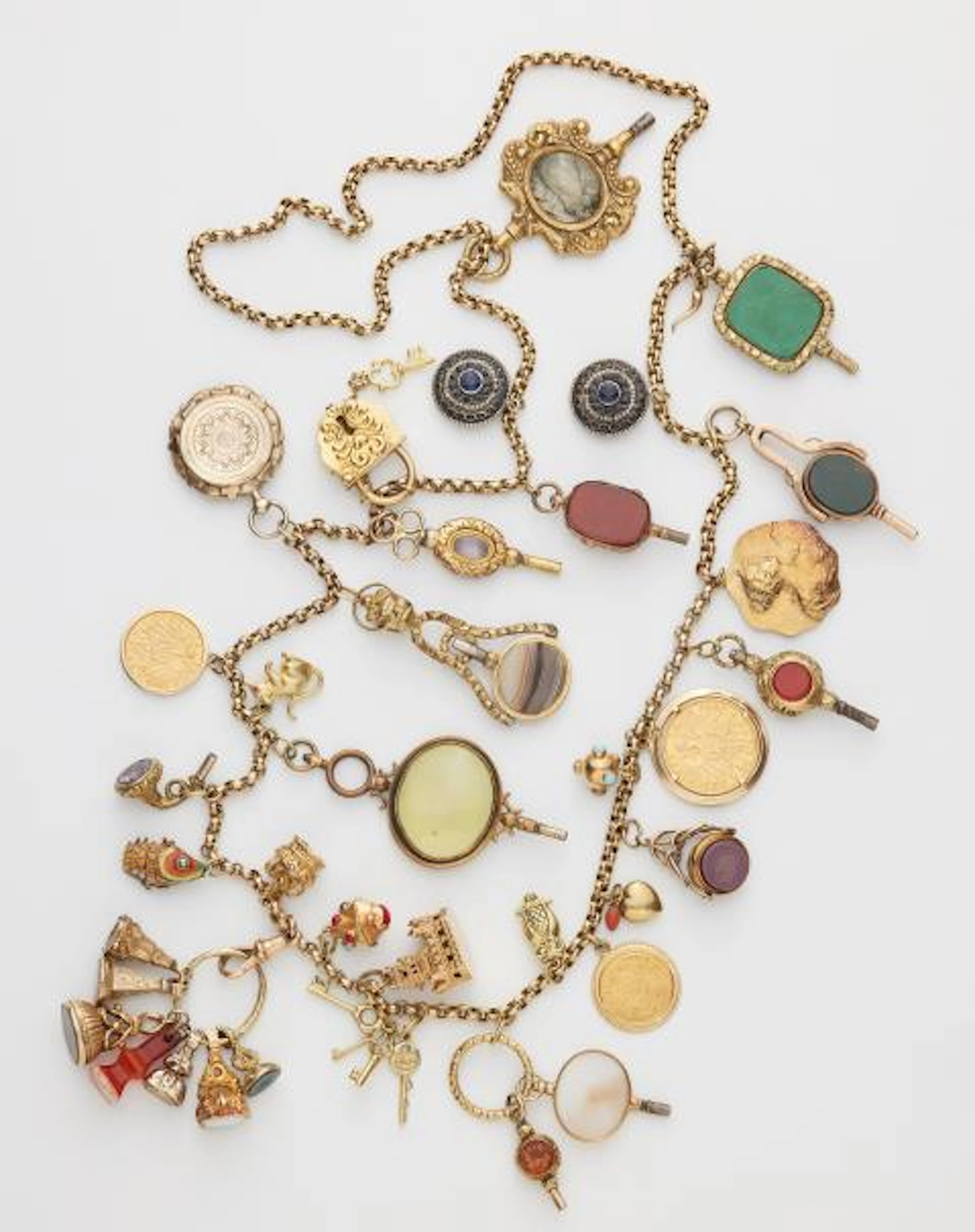 A long 9k gold chain with 30 partially multi-part gold and metal charms