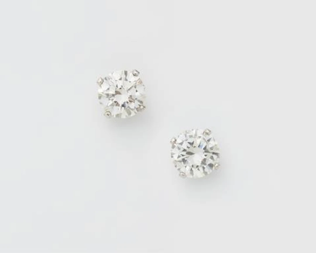 A pair of 18k white gold and brillant-cut diamond solitaire stud earrings.