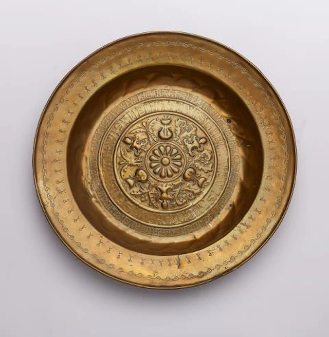A brass 'Beckenschlägerschüssel' with concentric grotesques
