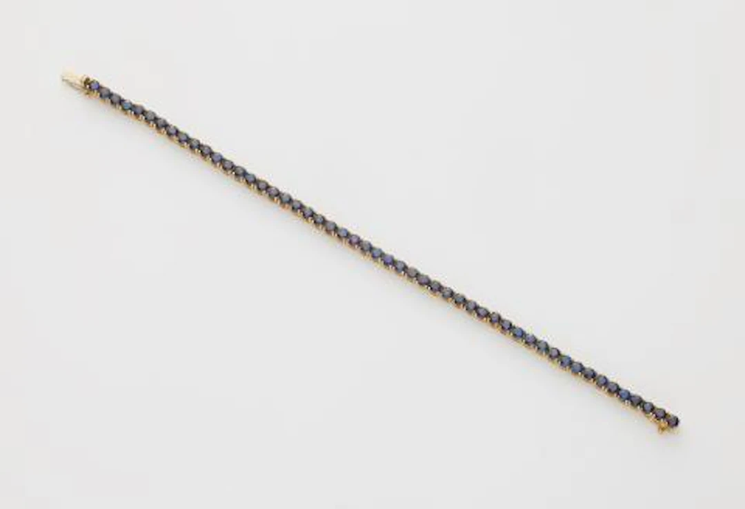 An 18k white gold and sapphire rivière bracelet.