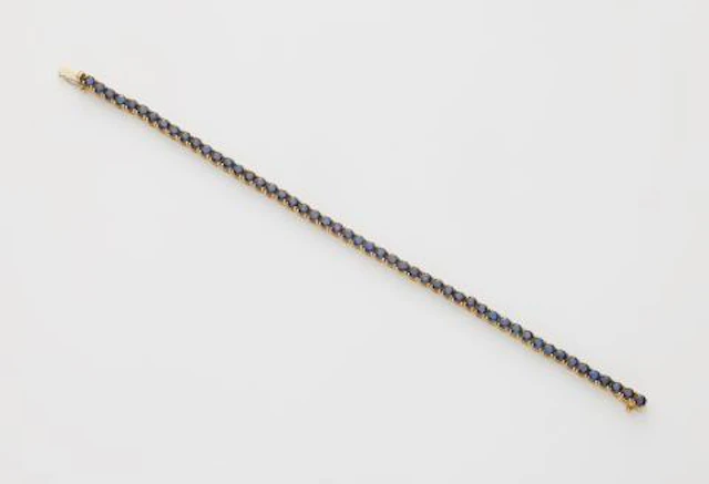 An 18k white gold and sapphire rivière bracelet.