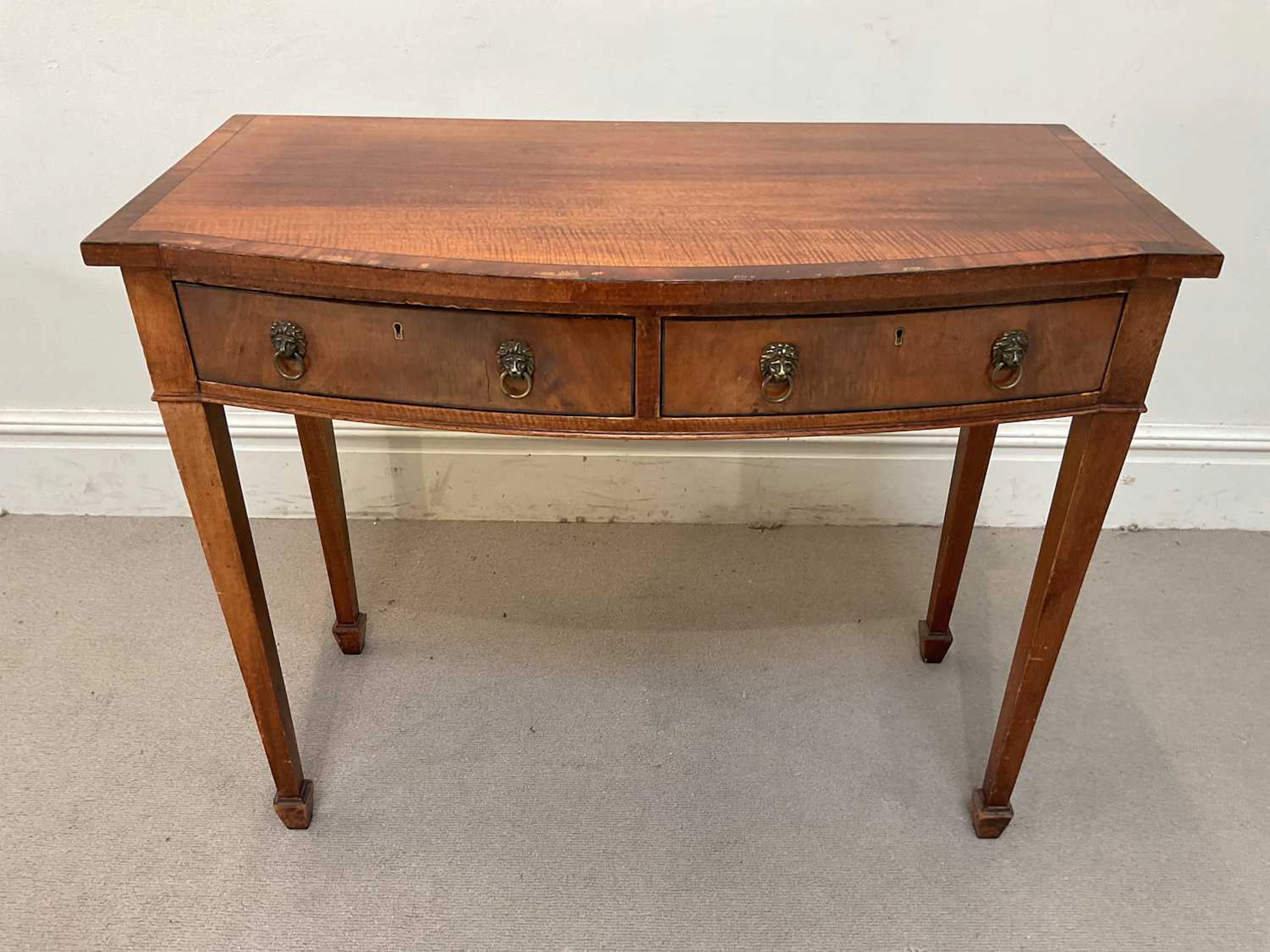 A reproduction mahogany bowfront two drawer cutlery/side table