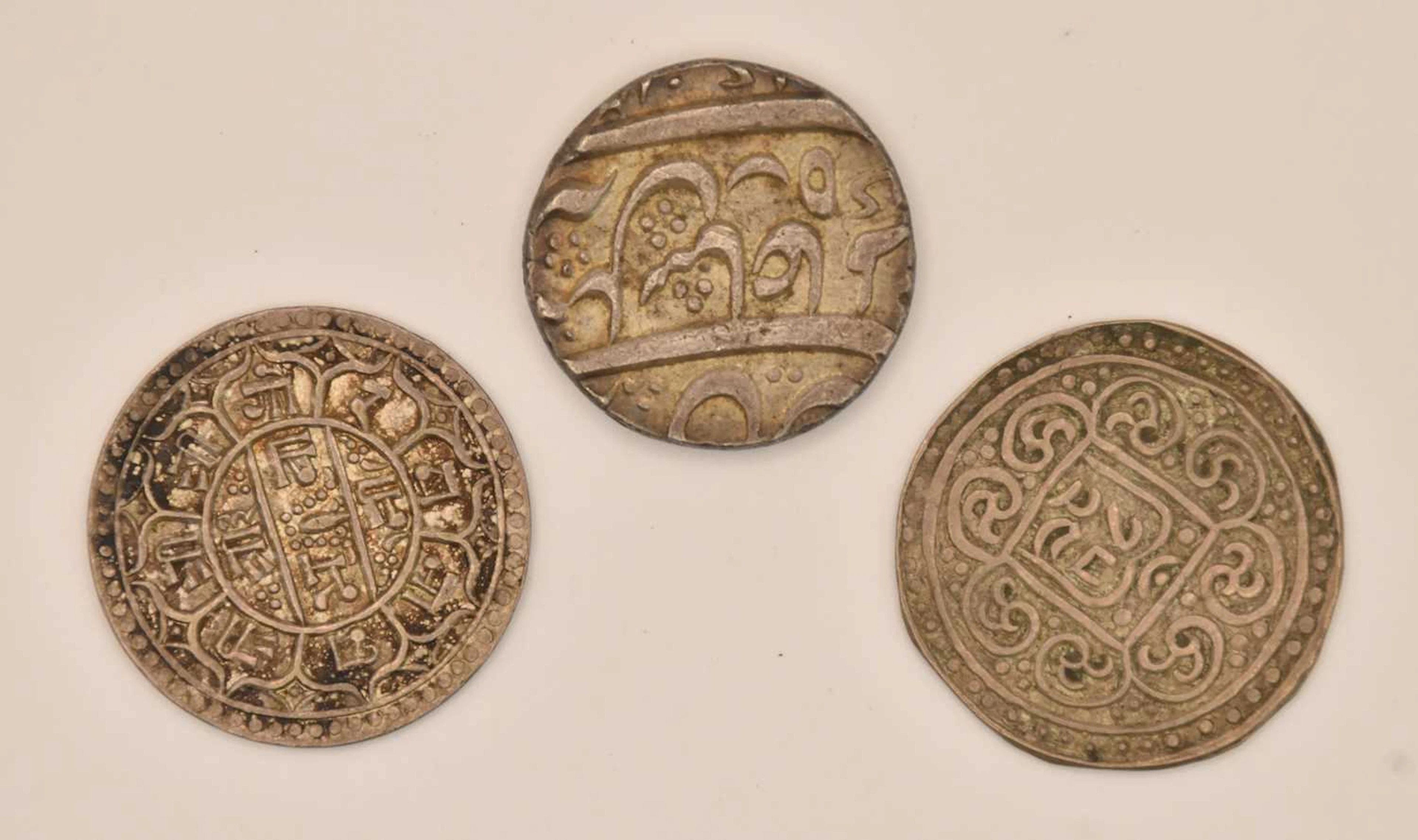 Three assorted silver coins comprising a Tibetan 1 tangka