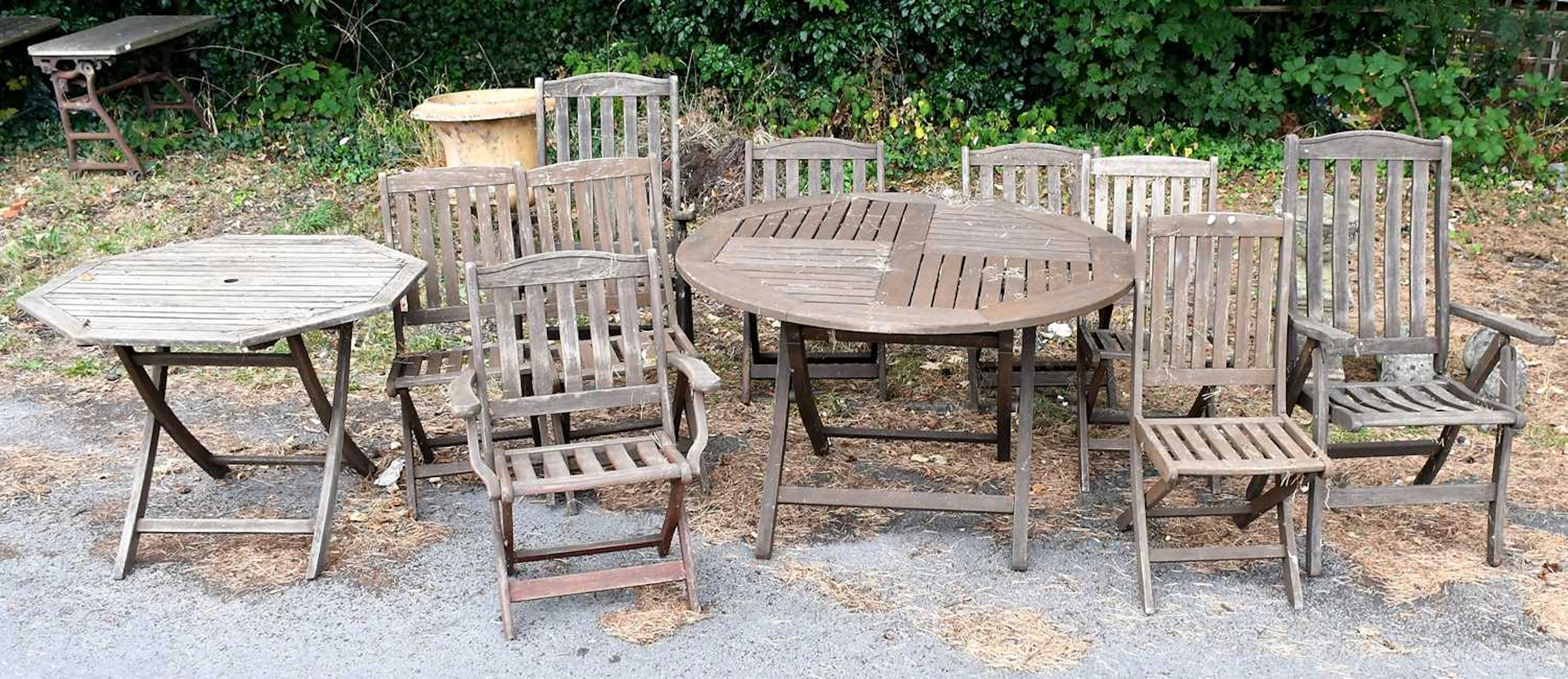 A collection of teak garden furniture comprising nine...