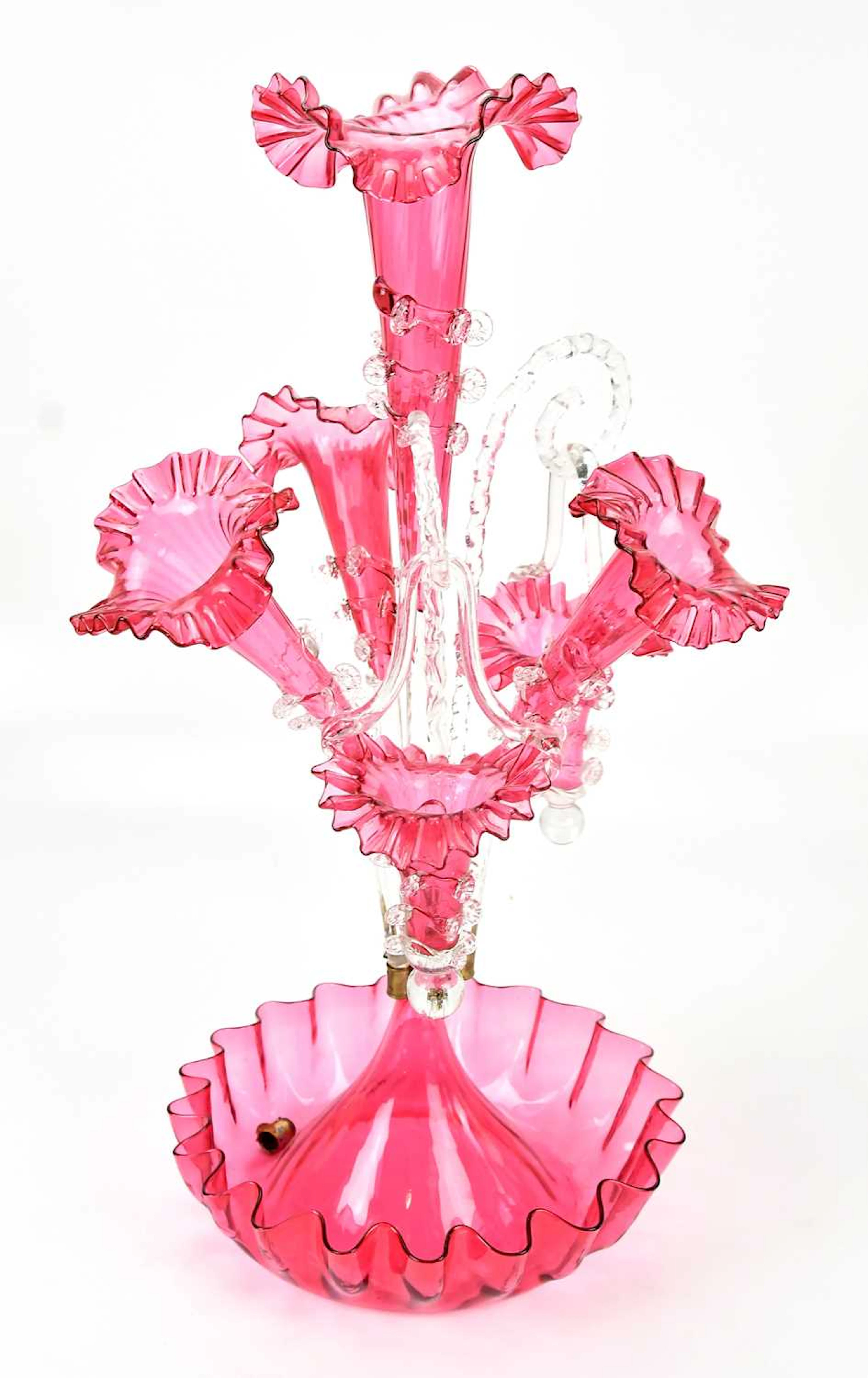 A Victorian cranberry glass epergne with three branches and three baskets