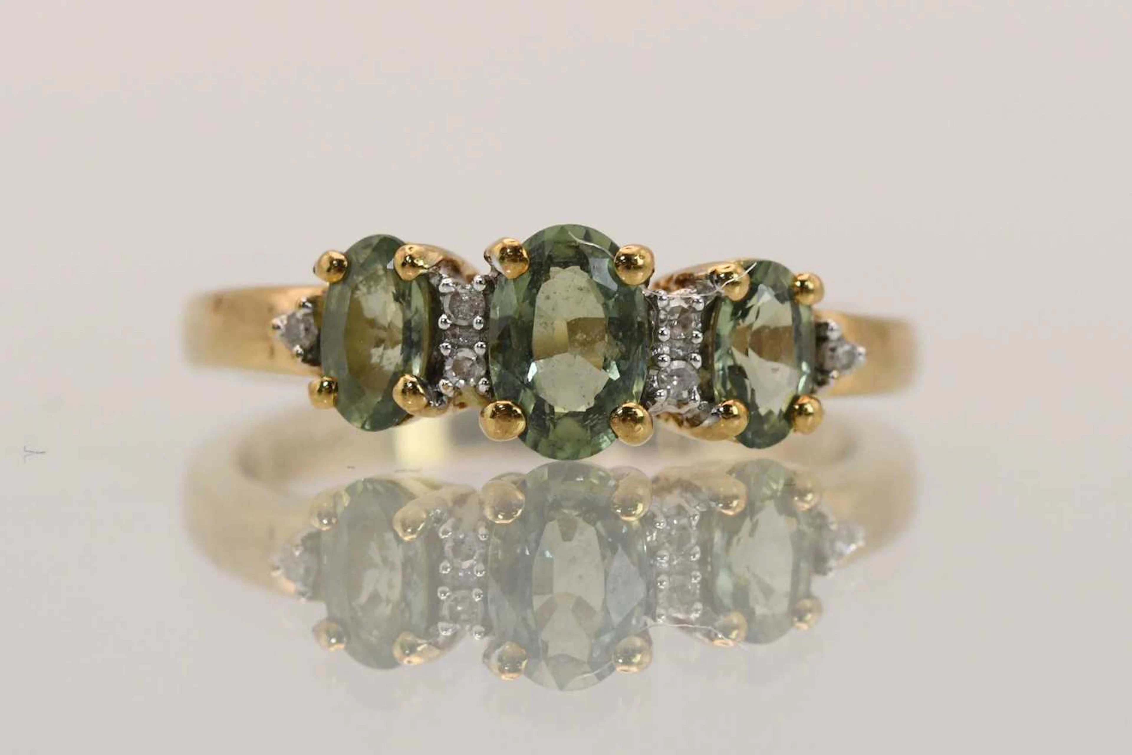 A 9ct yellow gold peridot and diamond set dress ring