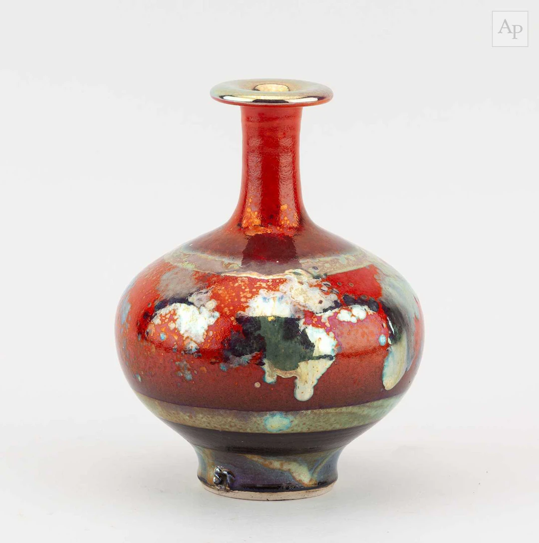 SUTTON TAYLOR (born 1943); an earthenware bottle covered...