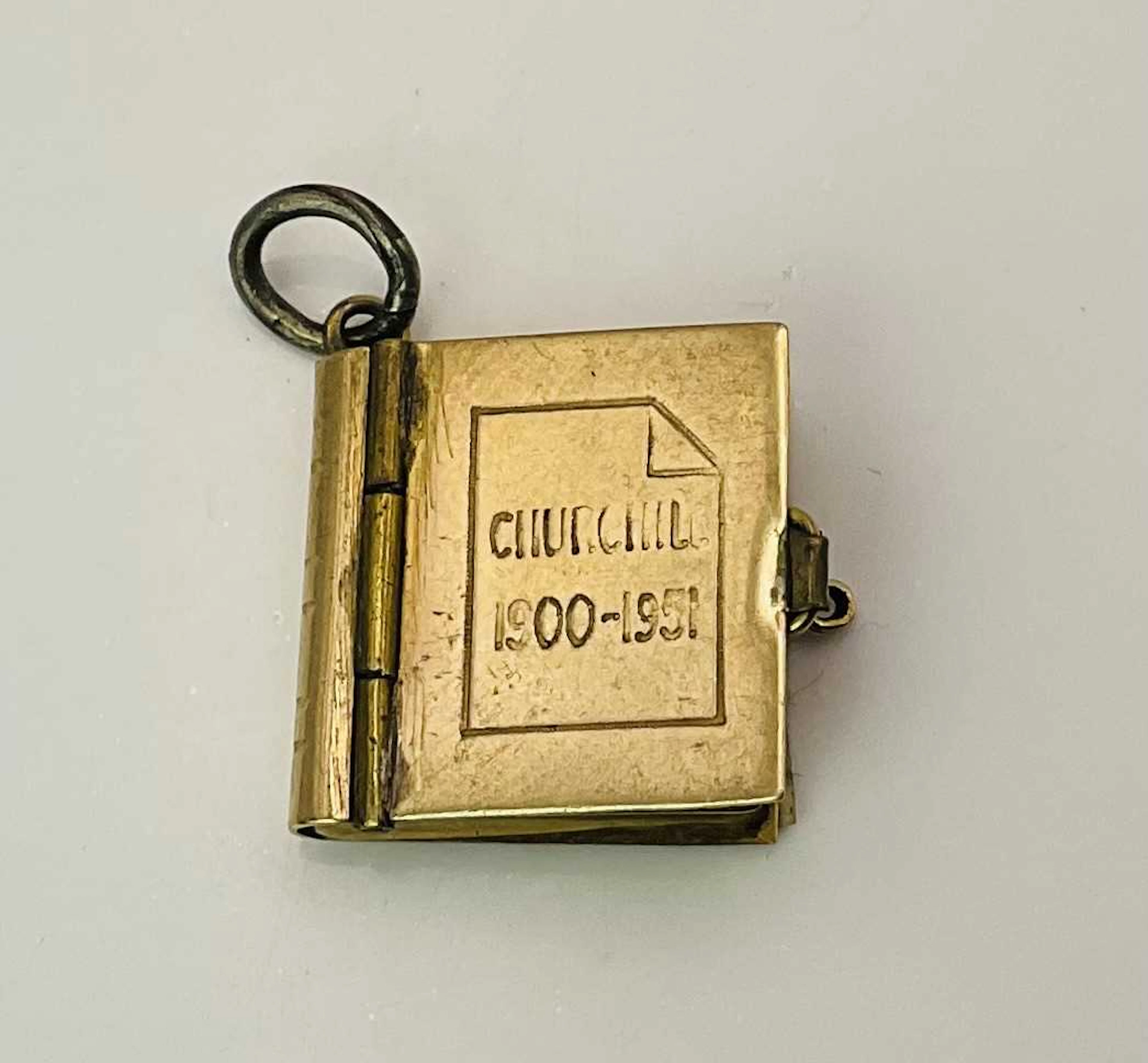 A 9ct gold miniature square book locket